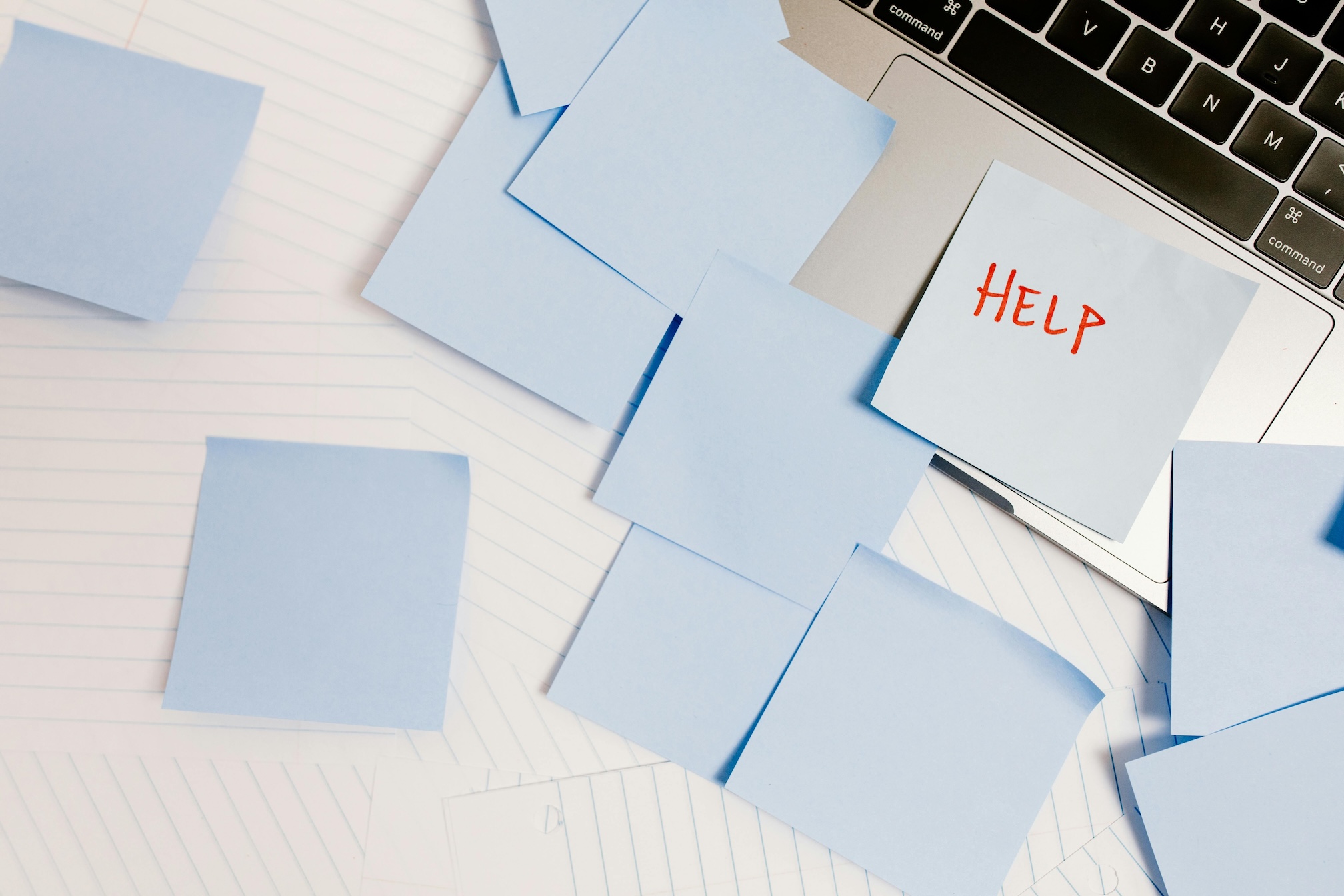 post-it notes scattered on a laptop