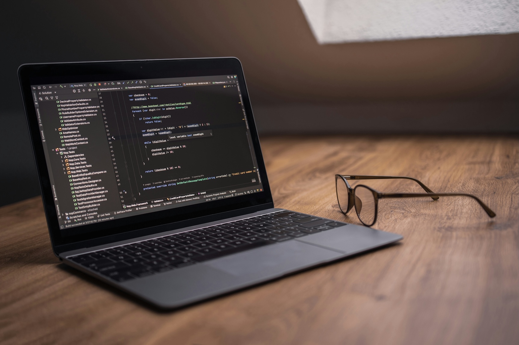 laptop on a workspace with code on the screen