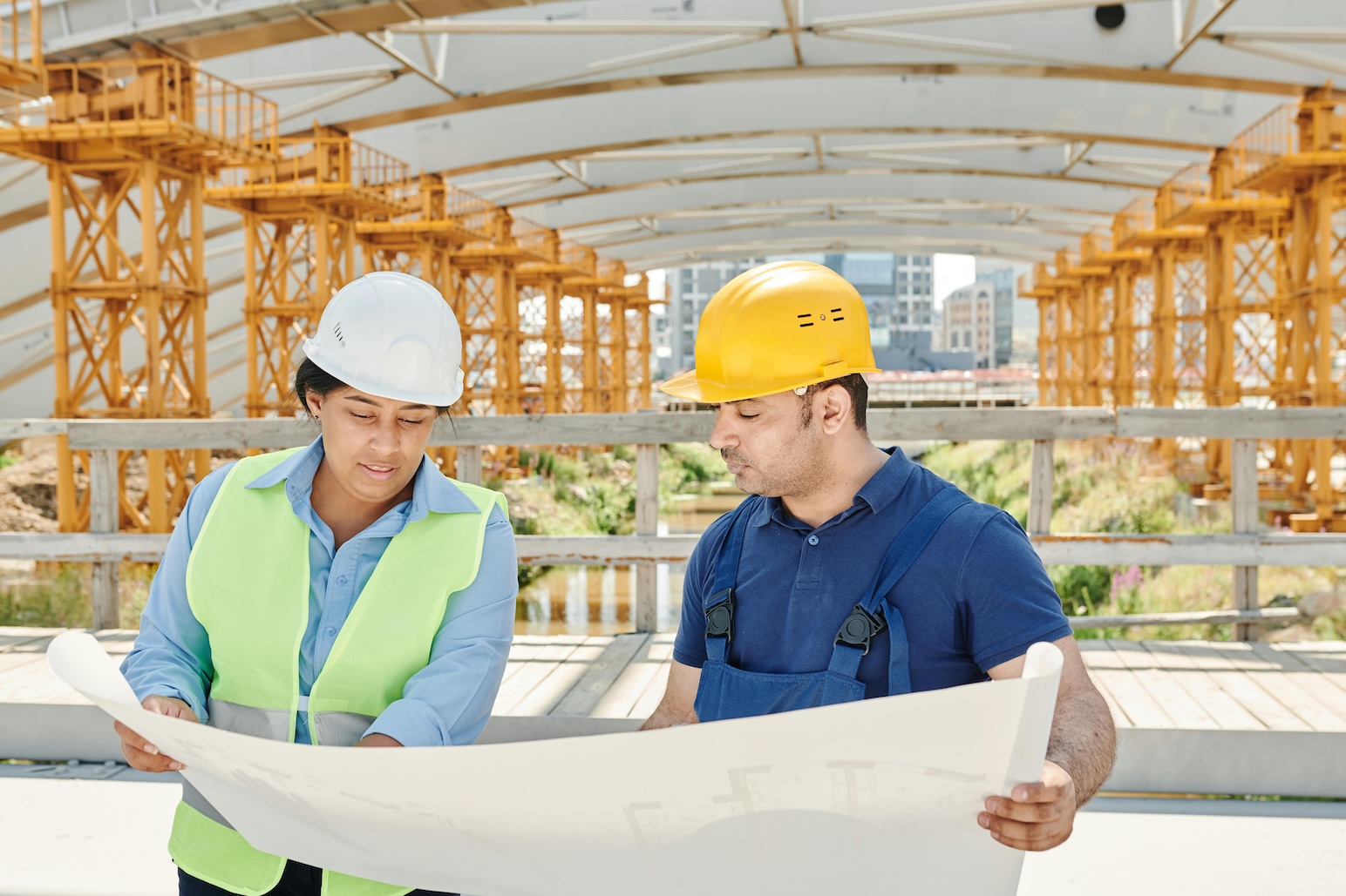 two construction workers looking at a blueprint
