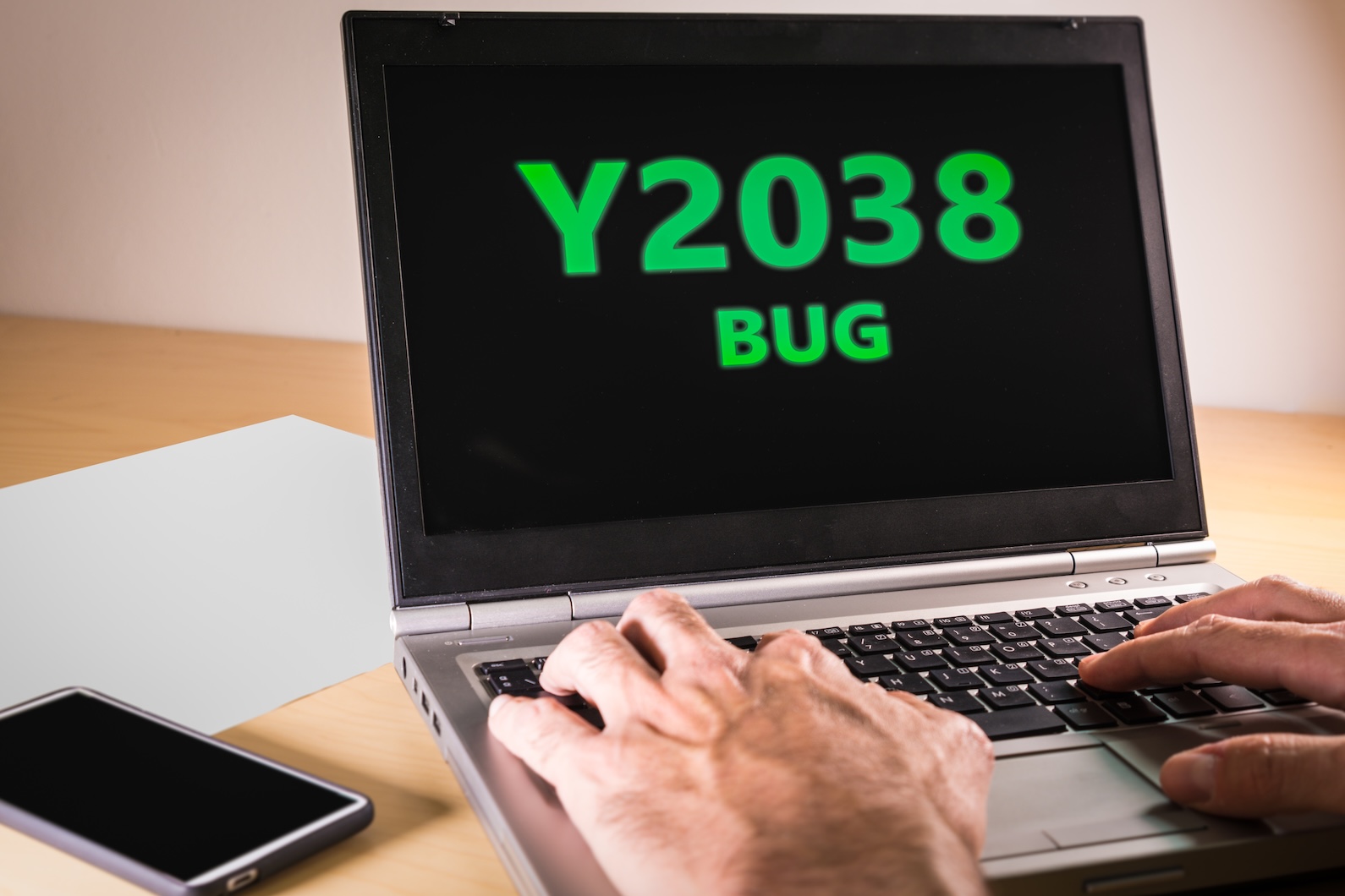 User on a laptop computer with Y2038 bug on the screen