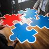 Team members fitting puzzle pieces together