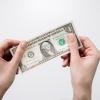 Person holding a dollar bill