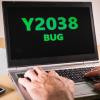 User on a laptop computer with Y2038 bug on the screen