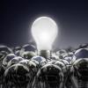 a lit lightbulb above unlit lightbulbs 