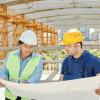 two construction workers looking at a blueprint