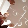 team putting puzzle pieces together